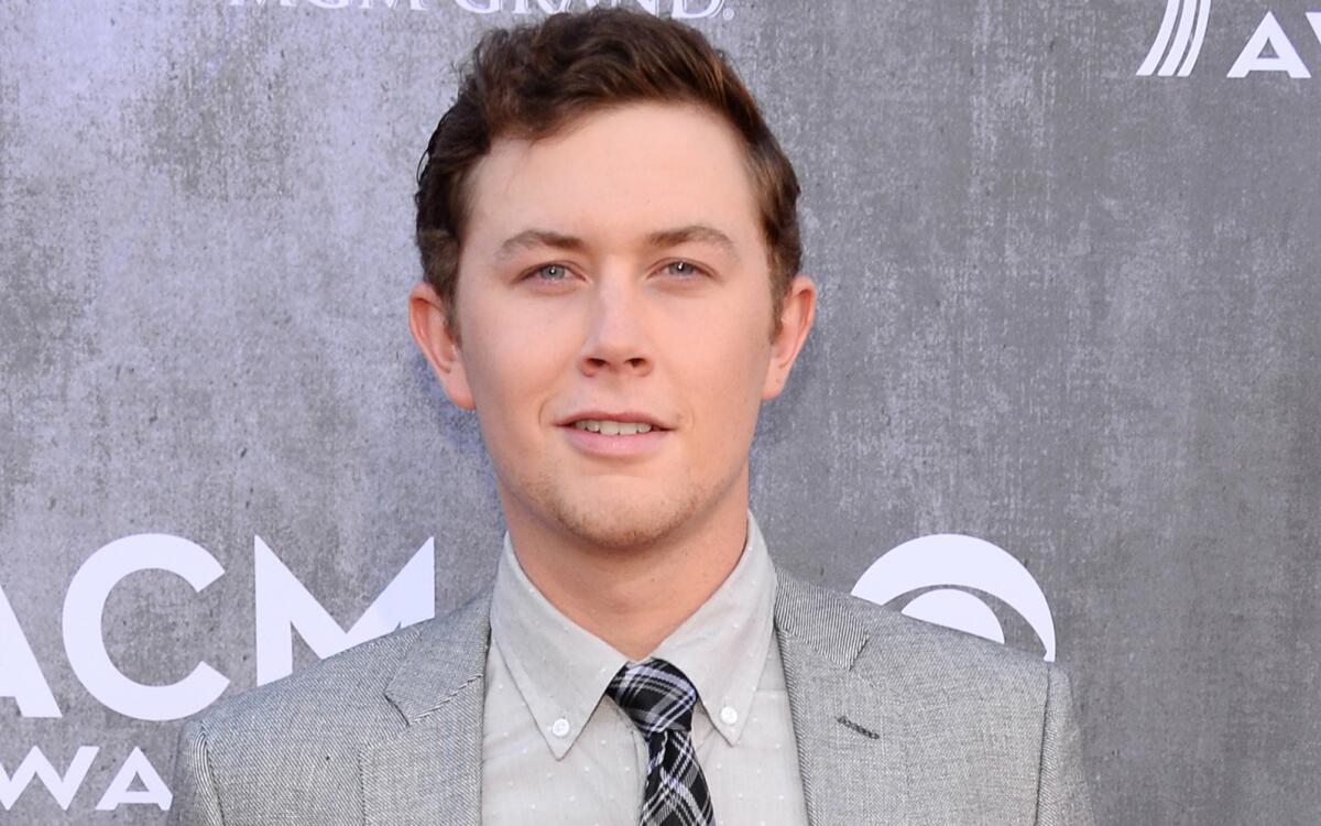 Scotty McCreery, shown at the 2014 Academy of Country Music Awards in Las Vegas in April, was among the victims of an armed home-invasion robbery in the wee hours Monday morning.