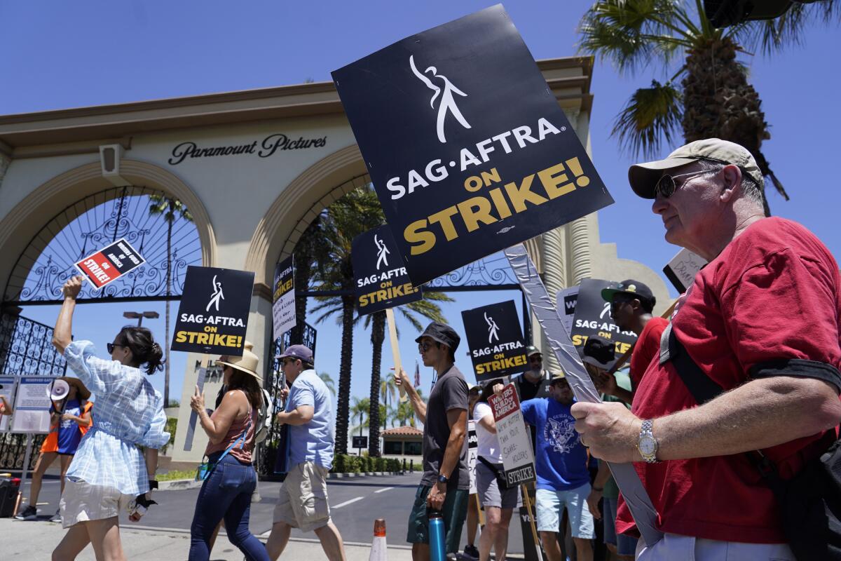  Striking writers and actors picket outside Paramount studios in Los Angeles 