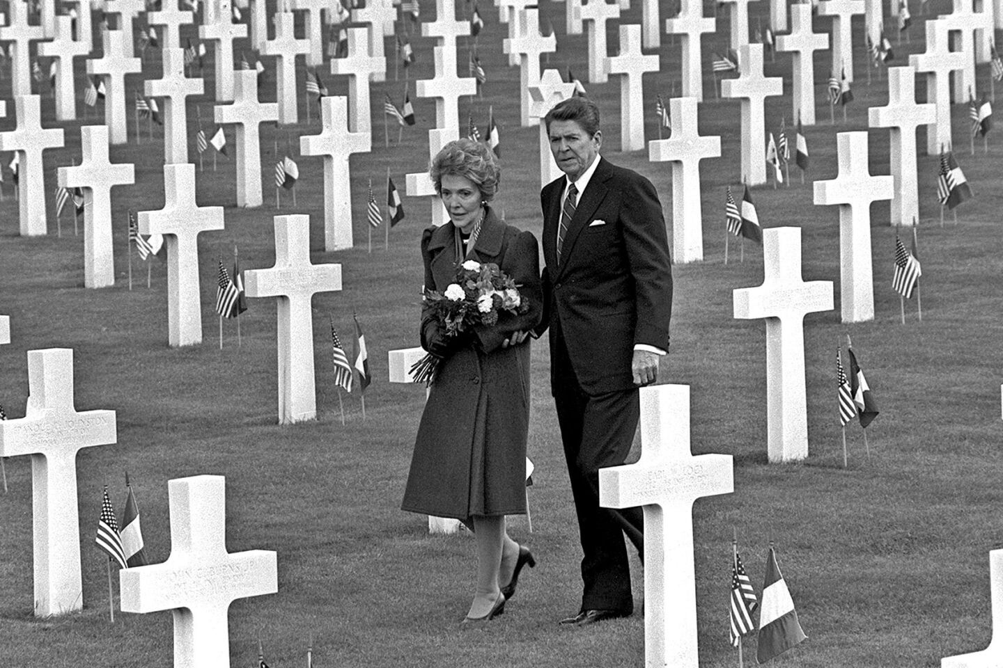 The Reagans walk through Normandy American Cemetery above Omaha Beach in northern France on June 6, 1984, the 40th anniversary of the D-day invasion.