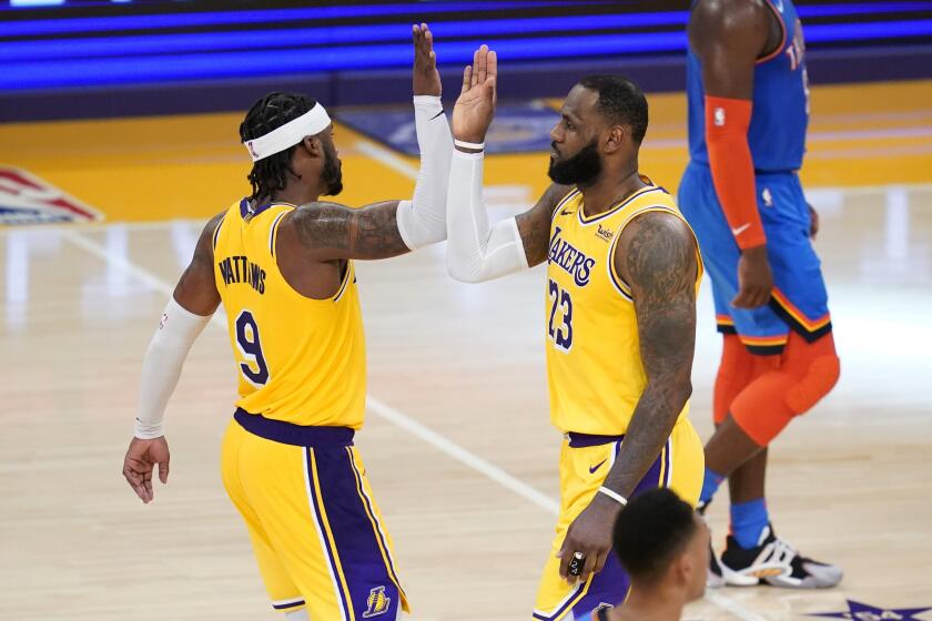 Lakers guard Wesley Matthews high-fives forward LeBron James (23) after the team's 114-113 overtime win Wednesday.