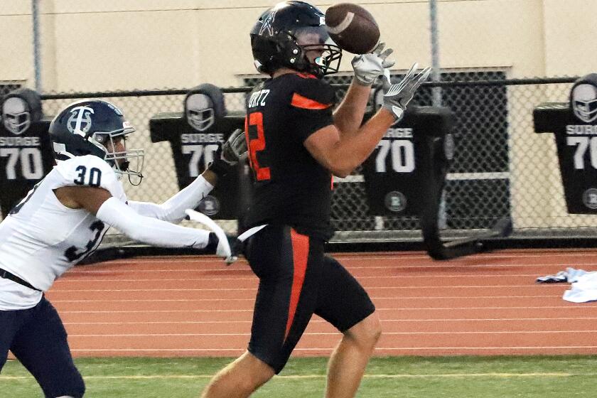 Huntington Beach's Steel Kurtz (12) makes a catch for a touchdown during Huntington Beach High School's Football team against Trabuco Hills High School's Football team in a nonleague game at Huntington Beach High School in Huntington Beach on Friday, August 30, 2024. (Photo by James Carbone)