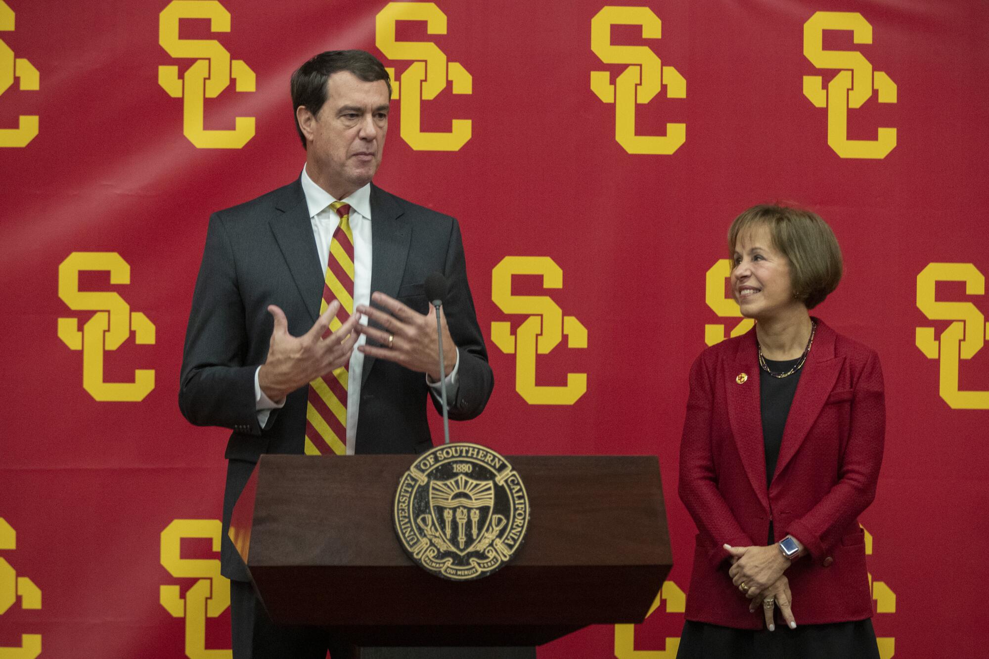 USC athletic director Mike Bohn speaks beside USC President Carol L. Folt