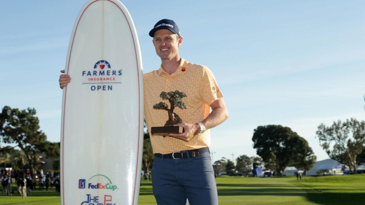 Justin Rose poses with the trophy after winning on the South Course during the final round of the the 2019 Farmers Insurance Open on Sunday.