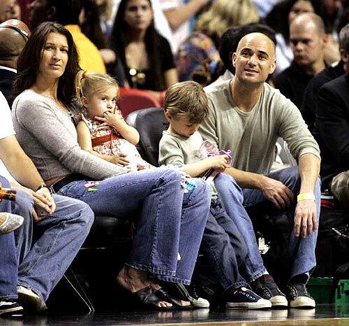 Andre Agassi and his wife, Steffi Graf, watch a Miami Heat game last season with their children, 4-year-old Jaden Gil and 2-year-old Jaz Elle.