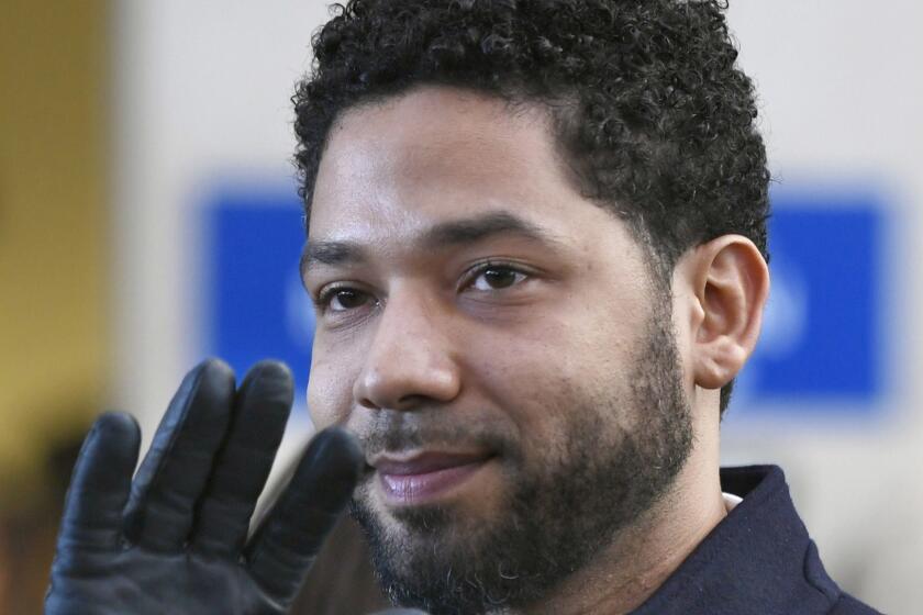 FILE - In this March 26, 2019, file photo, actor Jussie Smollett smiles and waves to supporters before leaving Cook County Court after his charges were dropped in Chicago. A deadline is looming for Smollett to pay over $130,000 to Chicago to cover part of the costs of an investigation into his report of a racist, anti-gay attack or risk getting slapped with a civil lawsuit. Thursday, April 4, is seven days since Mayor Rahm Emanuel's law department sent the "Empire" a March 28 letter demanding he writes them a money order or cashier's check for $130,106, plus 15 cents. It said he had seven days. (AP Photo/Paul Beaty, File)