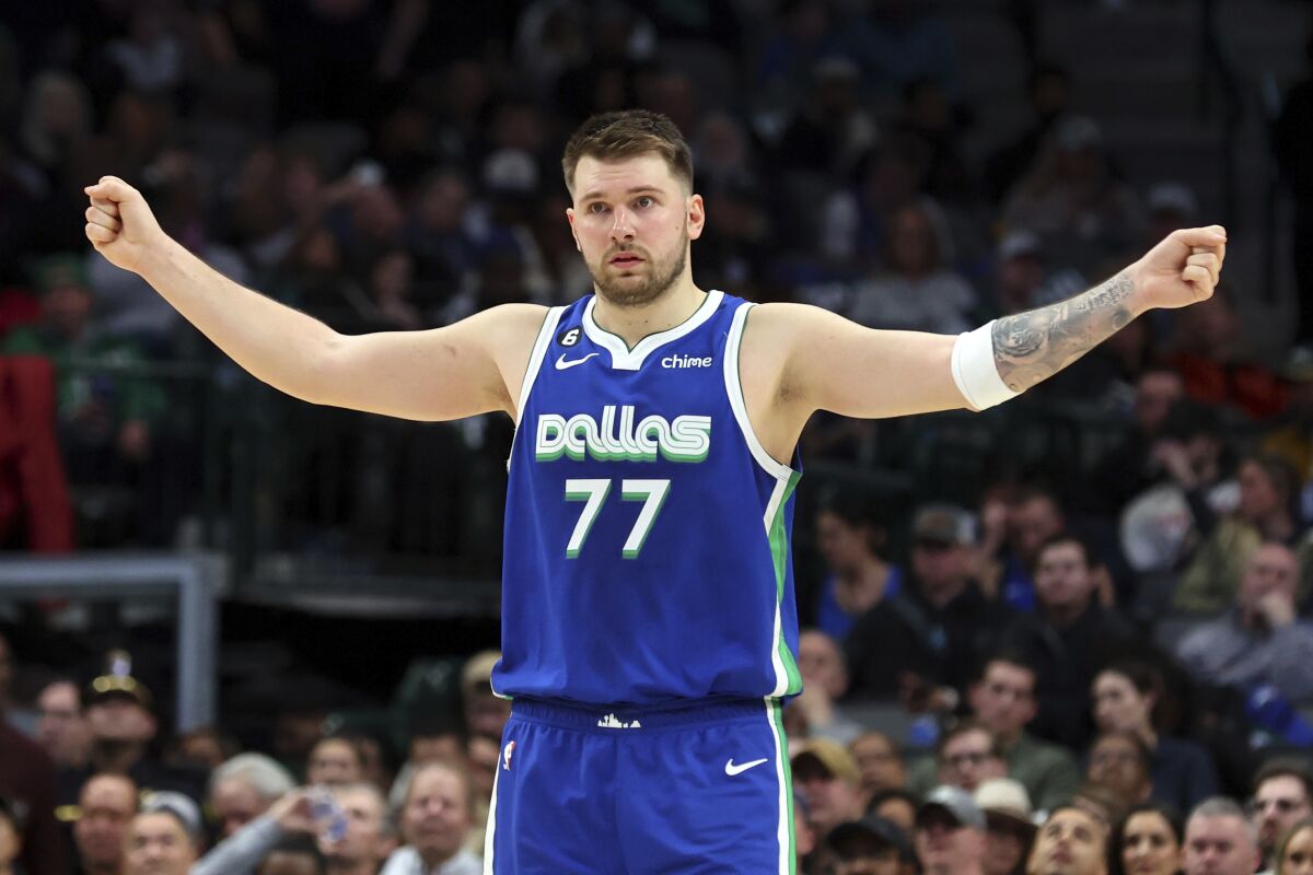 Dallas Mavericks guard Luka Doncic gestures on the court in the second half of an NBA basketball game against the Detroit Pistons, Monday, Jan. 30, 2023, in Dallas. (AP Photo/Richard W. Rodriguez)
