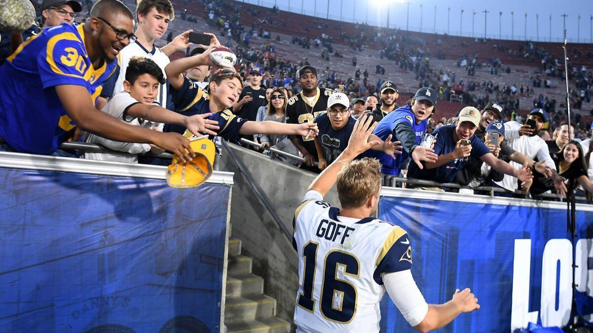 Rams quarterback Jared Goff runs off the field during a recent game at the Coliseum.