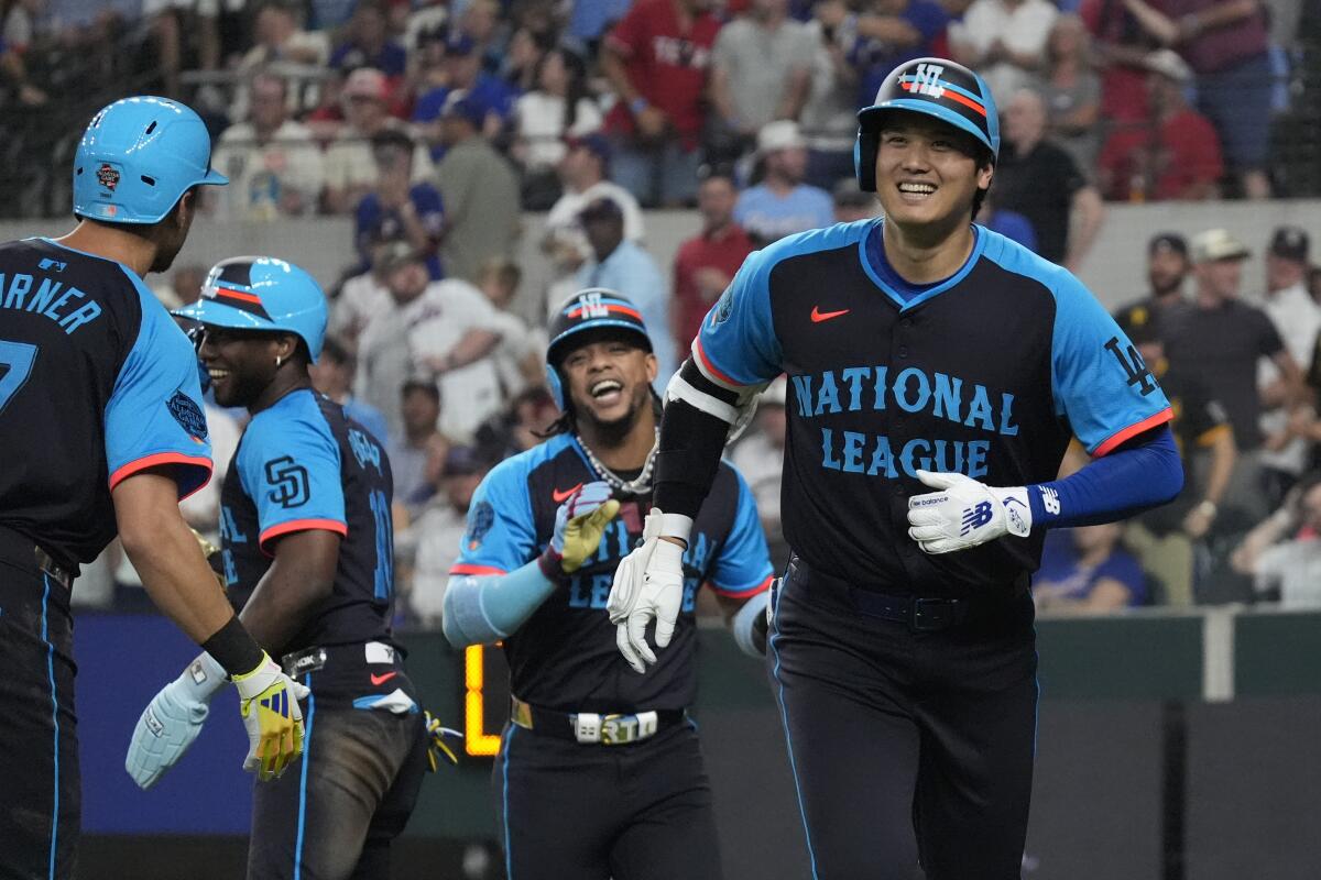 Shohei Ohtani, right, celebrates after hitting a home run for the National League in Tuesday's All-Star Game.