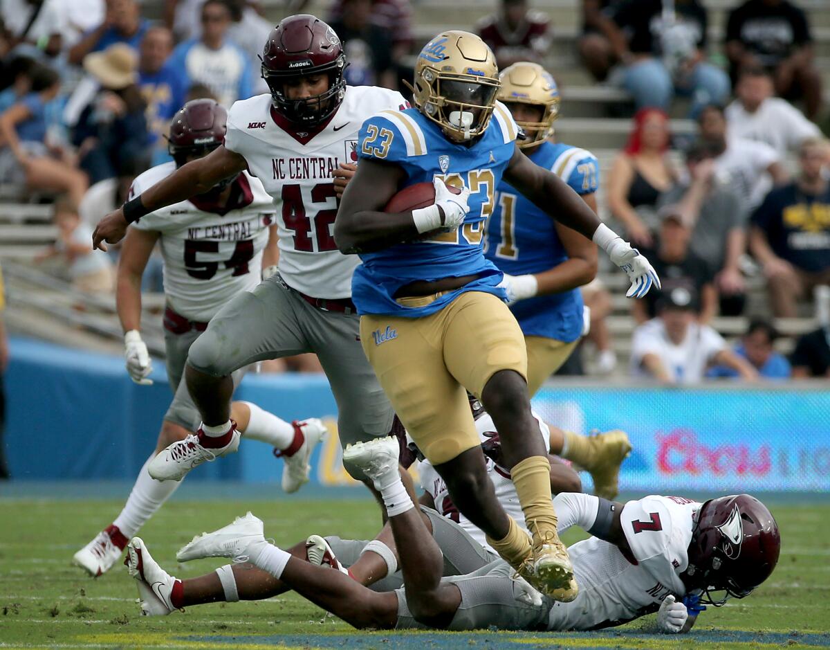 Anthony Adkins carries the ball for UCLA.