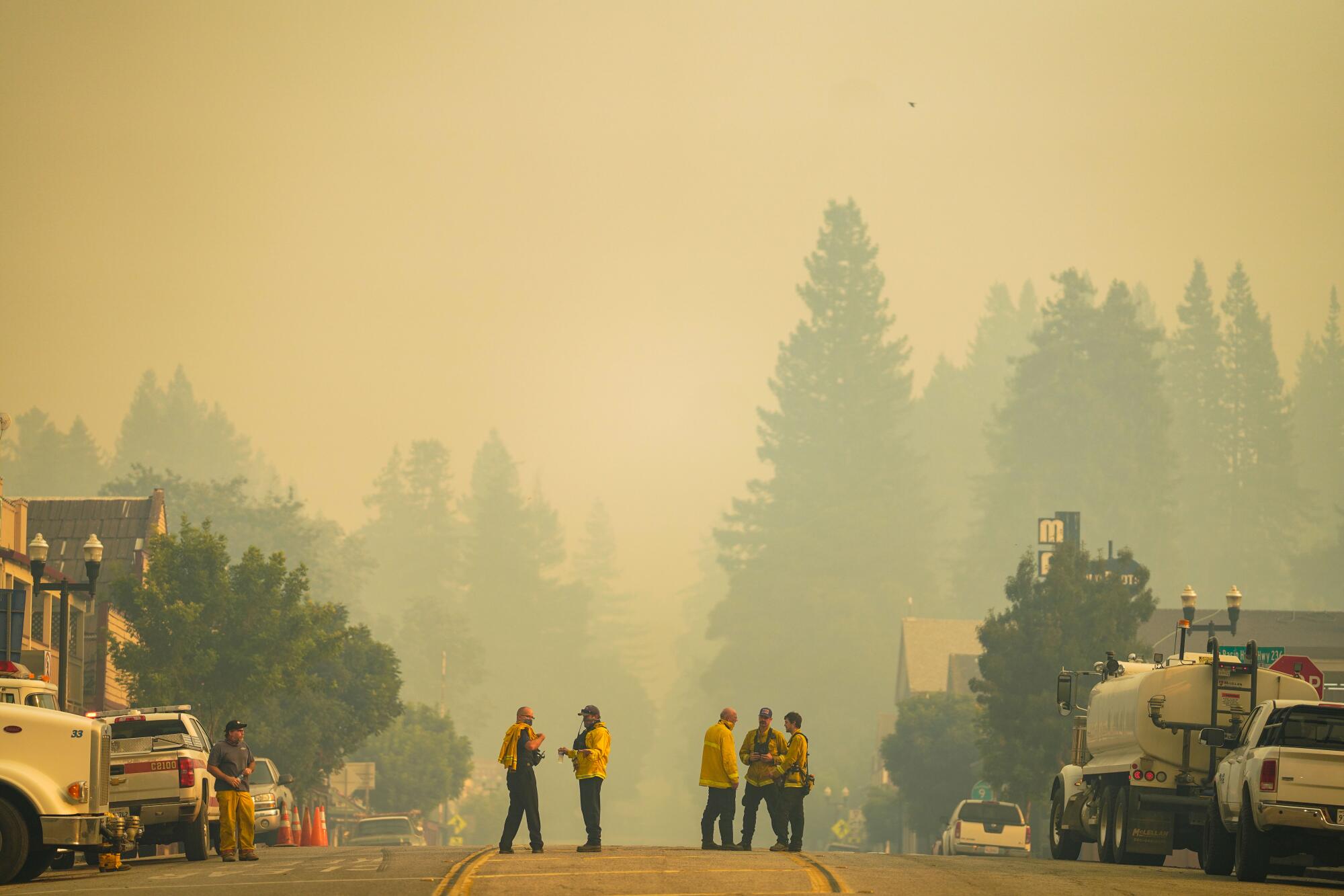 Ben Lomond firefighters work on a blaze at The Sequoia Retreat Center during the CZU August Lightning Complex Fires.
