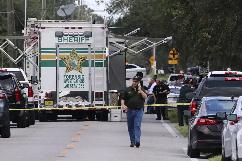 Polk County, Florida, police officers work at the scene of a shooting Sunday, Sept. 5, 2021, in Lakeland.