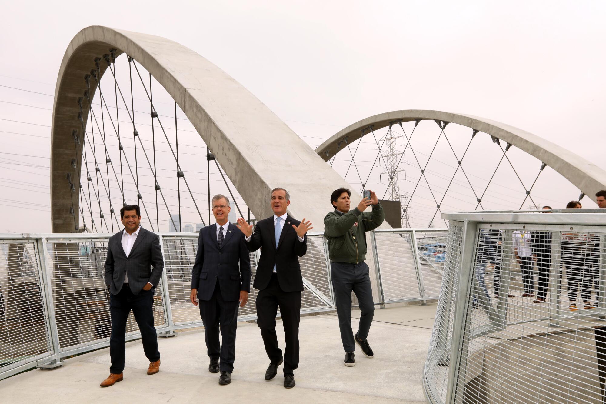 Four politicians visit the new 6th Street Viaduct.