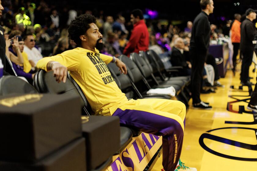 LOS ANGELES, CA - FEBRUARY 13, 2024: Newly acquired Los Angeles Lakers guard Spencer Dinwiddie (26) watches warm-ups from the bench before the game against the Detroit Pistons at Crypto.com Arena on February 13, 2024 in Los Angeles, California.(Gina Ferazzi / Los Angeles Times)