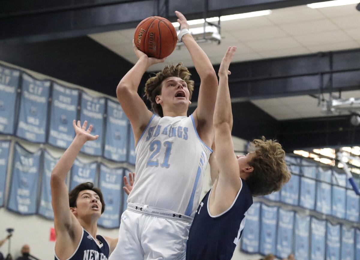 Corona del Mar's Scott Truninger drives to the basket in first quarter of the Battle of the Bay game.