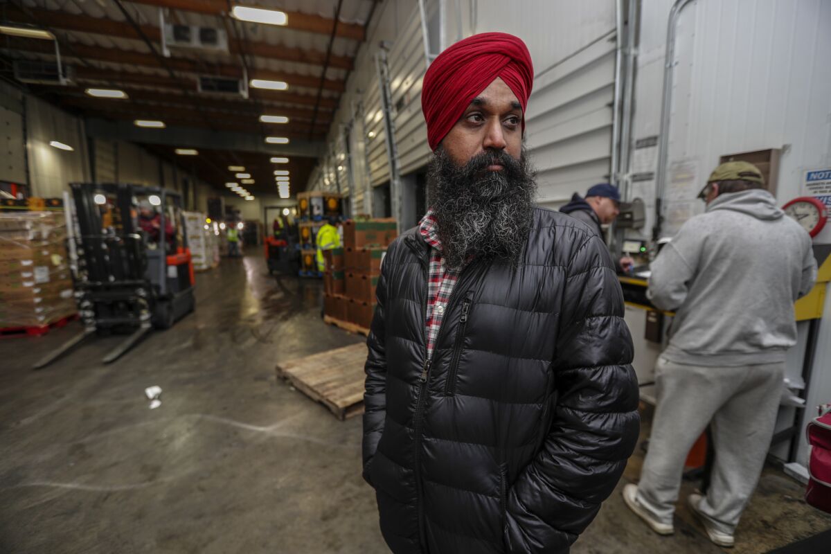 Singh waits for his turn to receive a load of produce at J.B.J. Dist. Inc. in Fullerton. (Irfan Khan / Los Angeles Times)