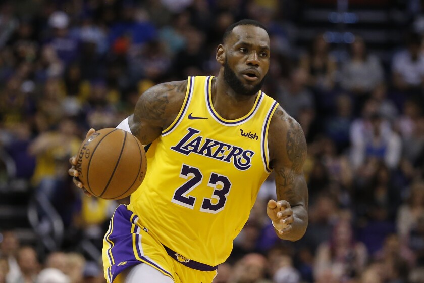 Lakers forward LeBron James dribbles the ball.