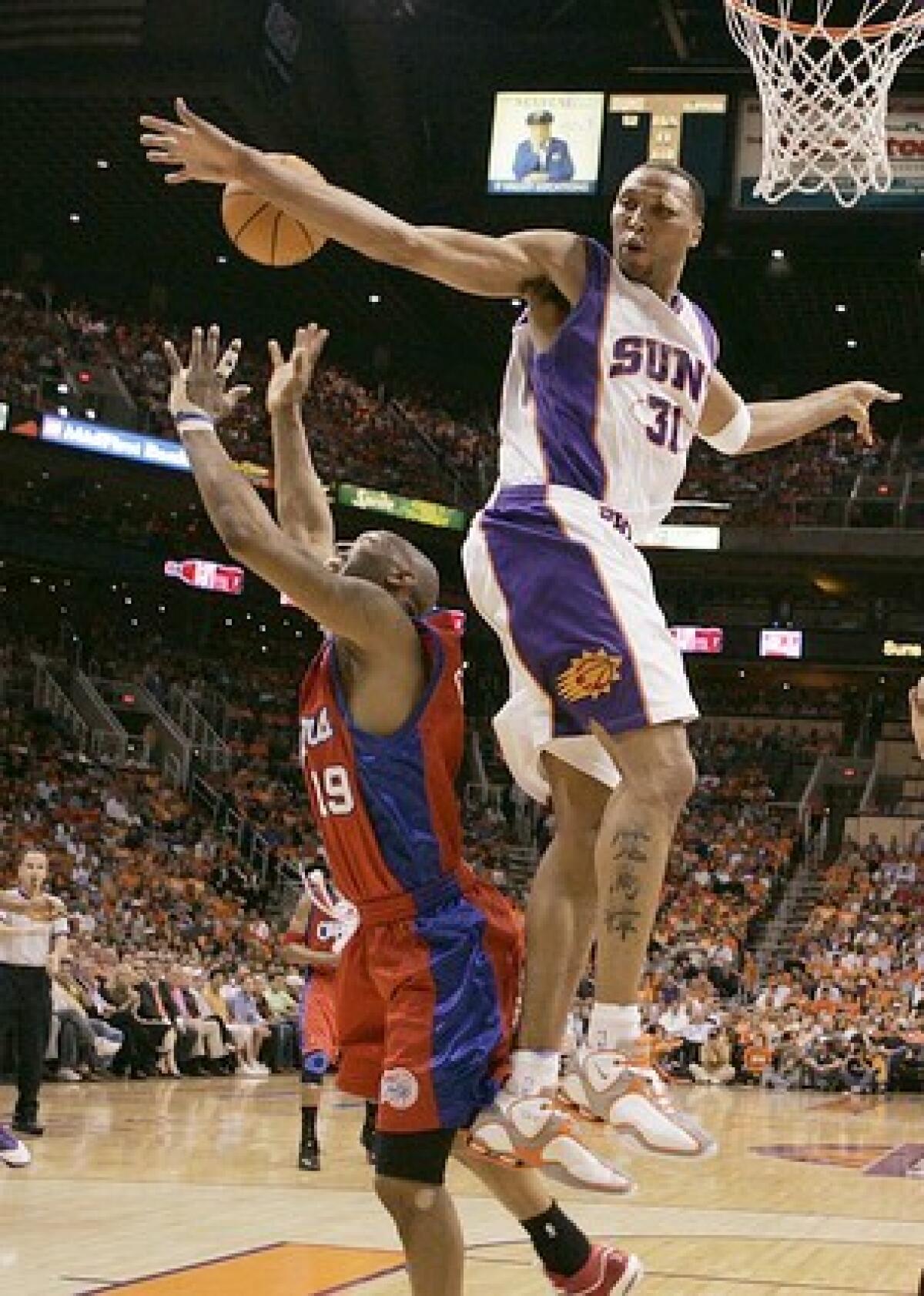 Clipper Sam Cassell is blocked by Phoenix Suns' Shawn Marion in Game 5 of the Second Round of the Western Conference Playoffs at the US Airways Center in Phoenix.
