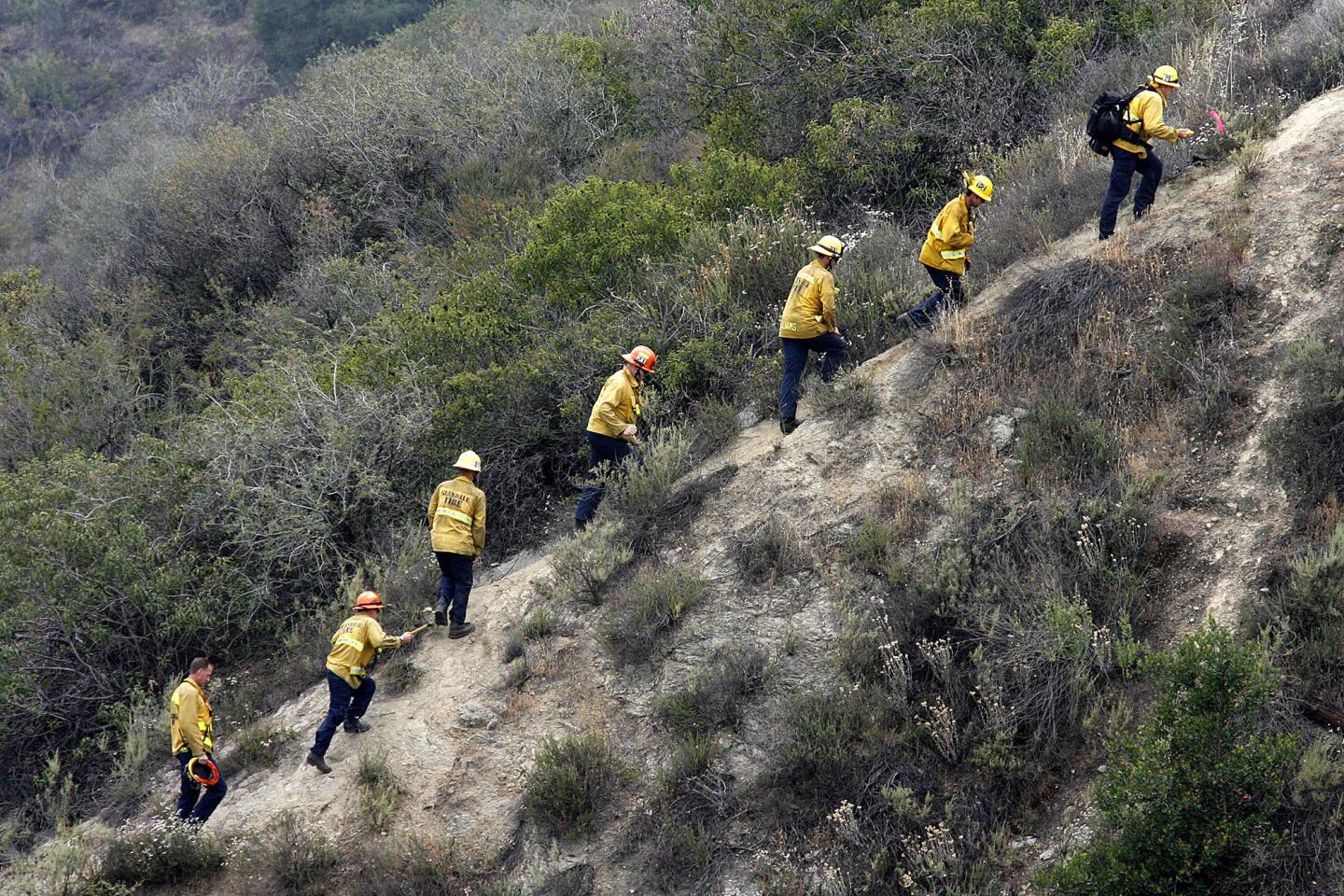 Photo Gallery: Glendale Police helicopter assists Gendale Fire Department gather hose left in hills after brush fire