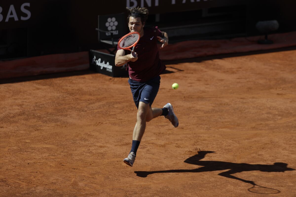 Taylor Fritz of the United States returns the ball to Britain's Daniel Evans during their match at the Italian Open tennis tournament, in Rome, Monday, May 10, 2021. (AP Photo/Gregorio Borgia)