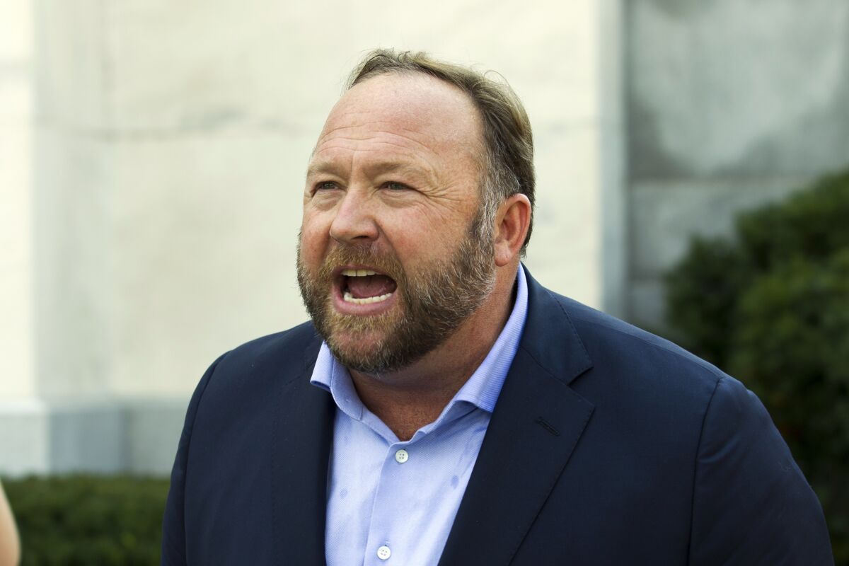 FILE - In this Sept. 5, 2018, file photo, Infowars host and conspiracy theorist Alex Jones speaks outside of the Dirksen building on Capitol Hill in Washington. A Connecticut judge has found Jones liable for damages in lawsuits brought by parents of children killed in the Sandy Hook Elementary School shooting. The parents of several children sued Jones over his claims that the massacre was a hoax. (AP Photo/Jose Luis Magana, File)