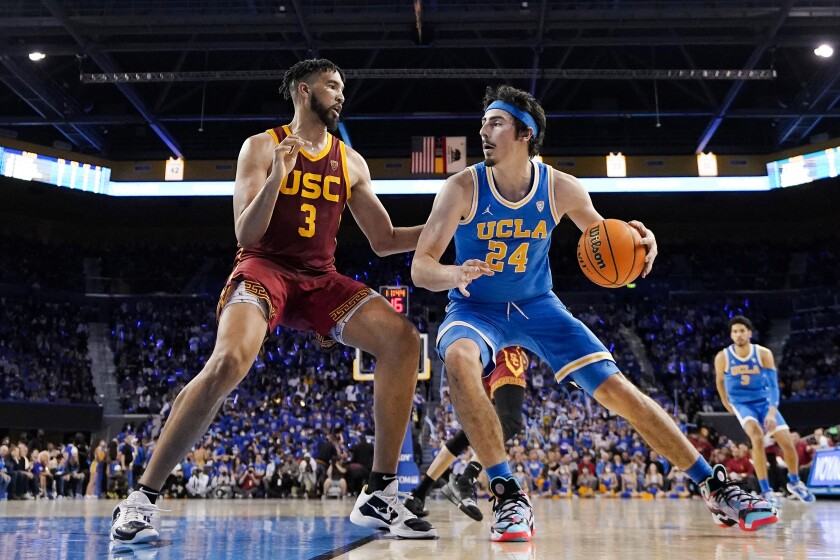 UCLA guard Jaime Jaquez Jr., right, tries to work past USC forward Isaiah Mobley during a game on March 5. 