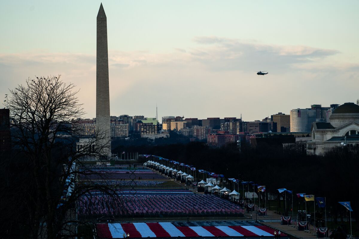 Marine One flies past the Washington Monument for the last time with President Trump aboard