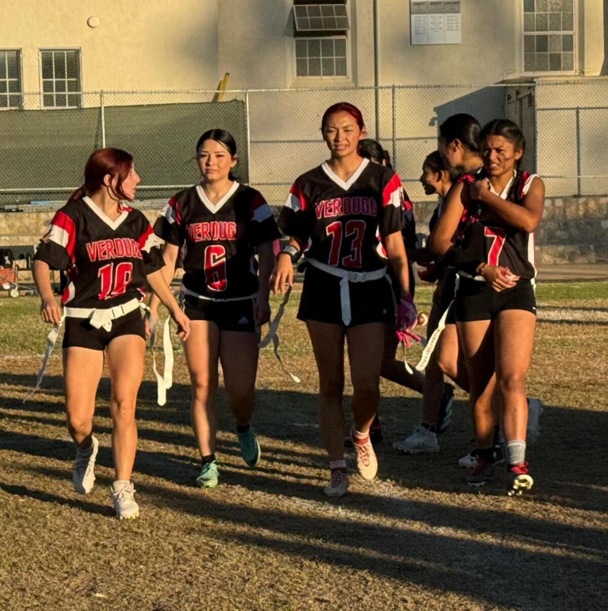 Verdugo Hills players, led by Julianna Sarabia (13), celebrate after historic 12-0 flag football win over Birmingham.