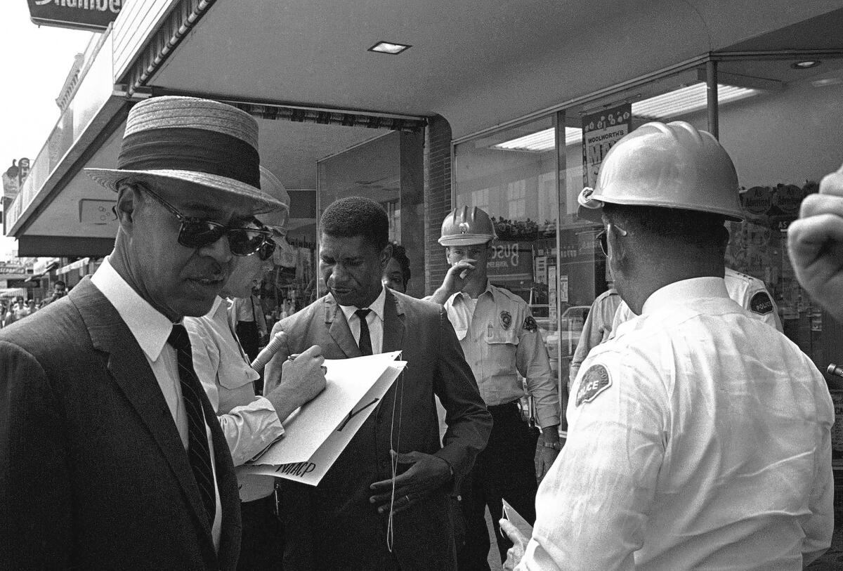 The NAACP's Roy Wilkins, left, and Medgar Evers are arrested in Jackson, Miss., days before Evers’ 1963 murder. His killer was finally convicted years later.