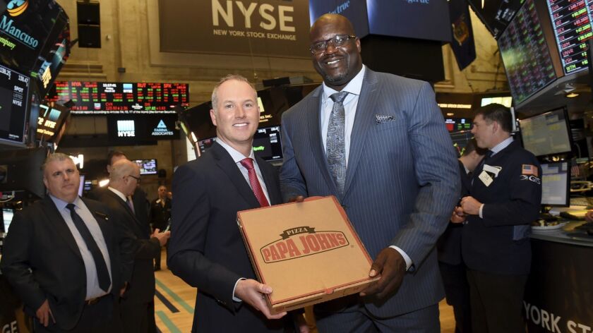 Papa John's CEO Steve Ritchie, left, and NBA Hall of Famer Shaquille O'Neal at the New York Stock Exchange on Friday.
