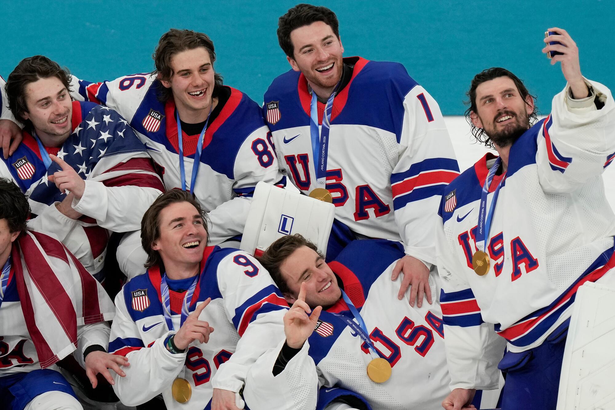 U.S. goalie Connor Hellebuyck takes a selfie with his teammates after their 2-1 overtime victory over Canada.