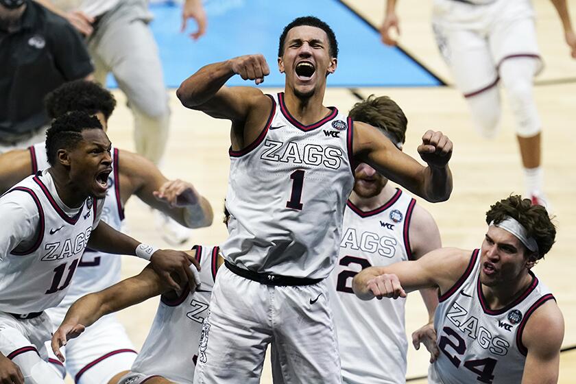 Gonzaga's Jalen Suggs celebrates with teammates after making a last-second shot in overtime to lift the Bulldogs over UCLA on Saturday.