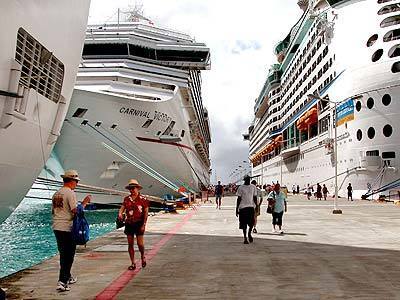 Cruise ships line the dock and harbor of Dutch St. Martin on a particularly busy January day when nine ships visited, depositing more than 25,000 shoppers and sightseers for a few hours.
