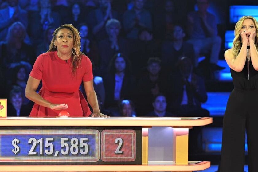 "Press Your Luck" contestant, FaLawna Barton, of Escondido, presses the button on Aug. 18 show as host Elizabeth Banks views.