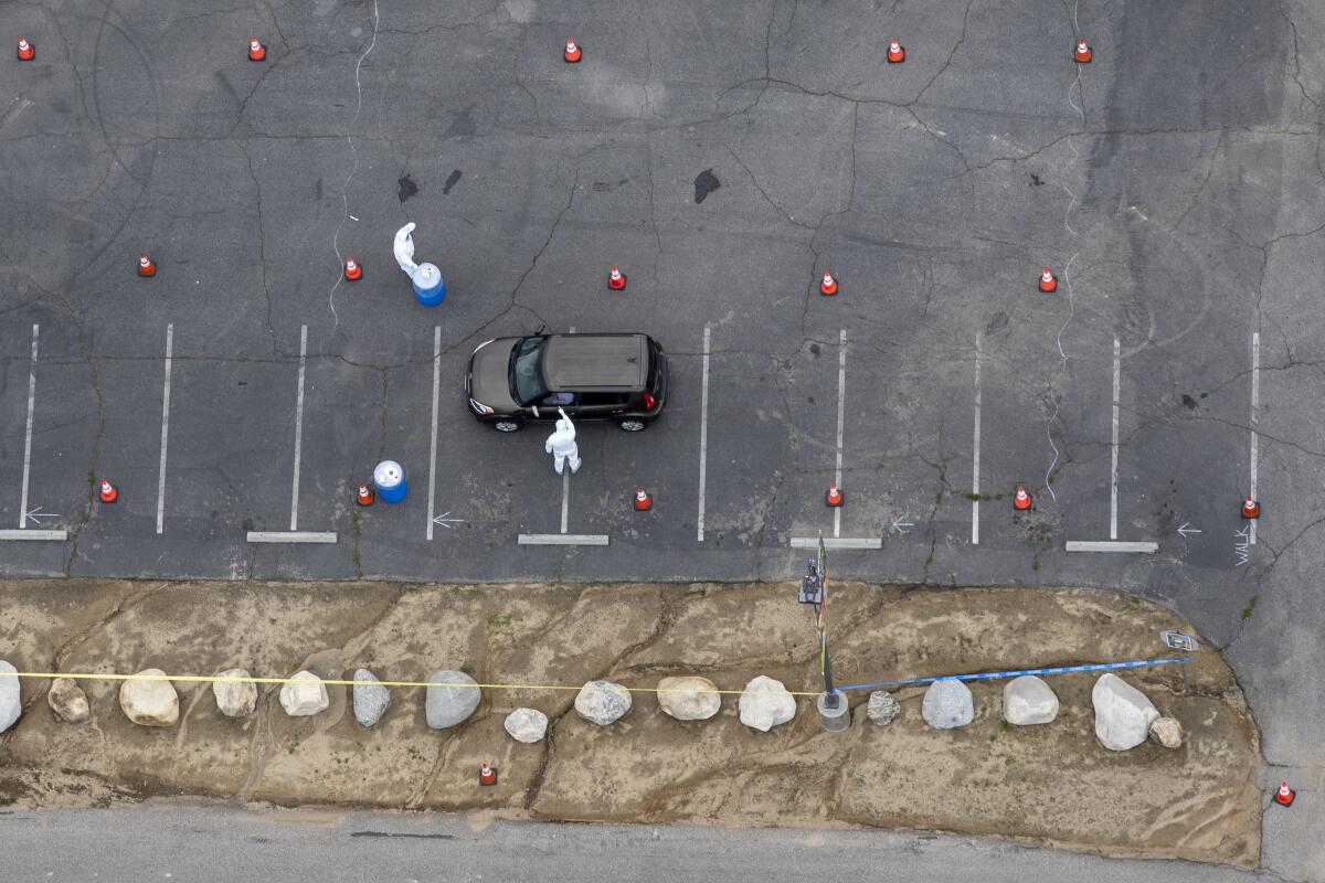 A driver at a drive-through coronavirus testing site at Hansen Dam Recreation Area.