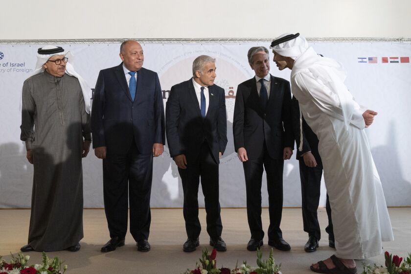 After meeting for the Negev Summit, Bahrain's Foreign Minister Abdullatif bin Rashid al-Zayani, left, Egypt's Foreign Minister Sameh Shoukry, Israel's Foreign Minister Yair Lapid, U.S. Secretary of State Antony Blinken, Morocco's Foreign Minister Nasser Bourita, and United Arab Emirates' Foreign Minister Sheikh Abdullah bin Zayed Al Nahyan, talk while posing for a photograph Monday, March 28, 2022, in Sde Boker, Israel. (AP Photo/Jacquelyn Martin, Pool)