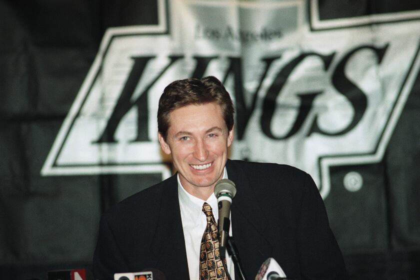 Wayne Gretzky smiles during a news conference in Los Angeles, Feb. 27, 1996 where he announced that he has been traded to the St. Louis Blues. Gretzky, the hockey great who failed to win a Stanley Cup in Los Angeles, was trade to the St. Louis Blues ending weeks of rumors and speculation about his future. (AP Photo/Kevork Djansezian)