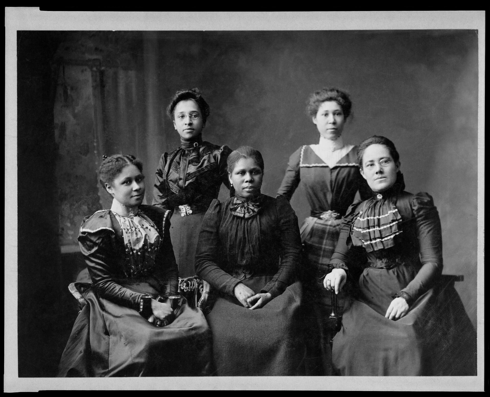 A black-and-white vintage photo of five Black women.
