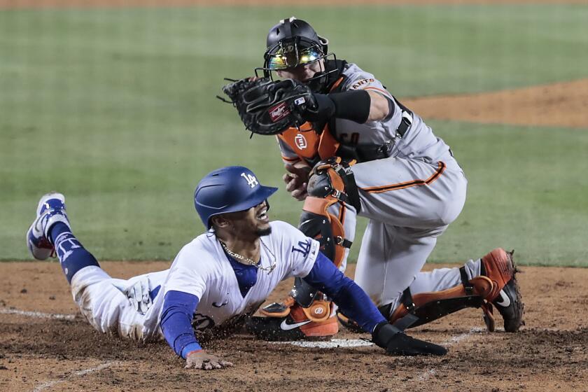 Los Angeles, CA, Thursday, July 23, 2020 - Los Angeles Dodgers right fielder Mookie Betts (50) slides safely into home, avoiding the tag of Giants catcher Tyler Heineman in the seventh inning at Dodger Stadium. (Robert Gauthier / Los Angeles Times)