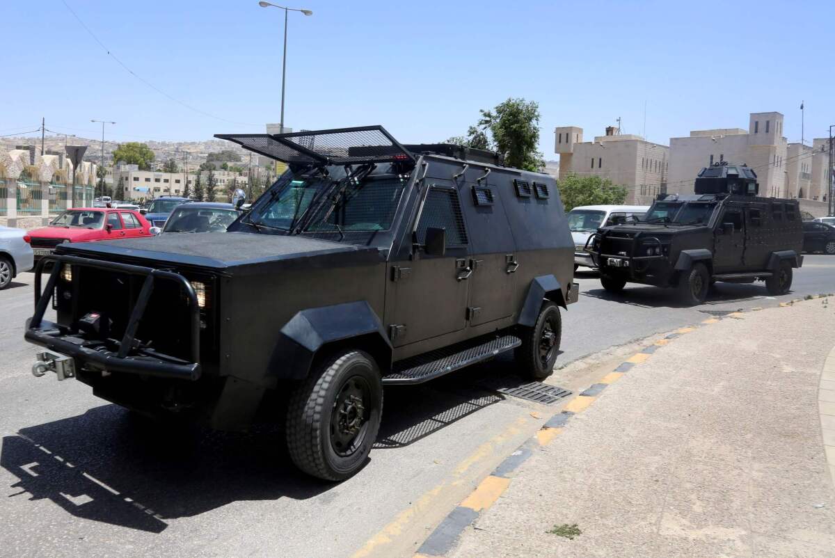 Jordanian security forces vehicles patrolling near the Jordanian intelligence agency office in the Baqaa camp north of the capital Amman following a gun attack on June 6, 2016.