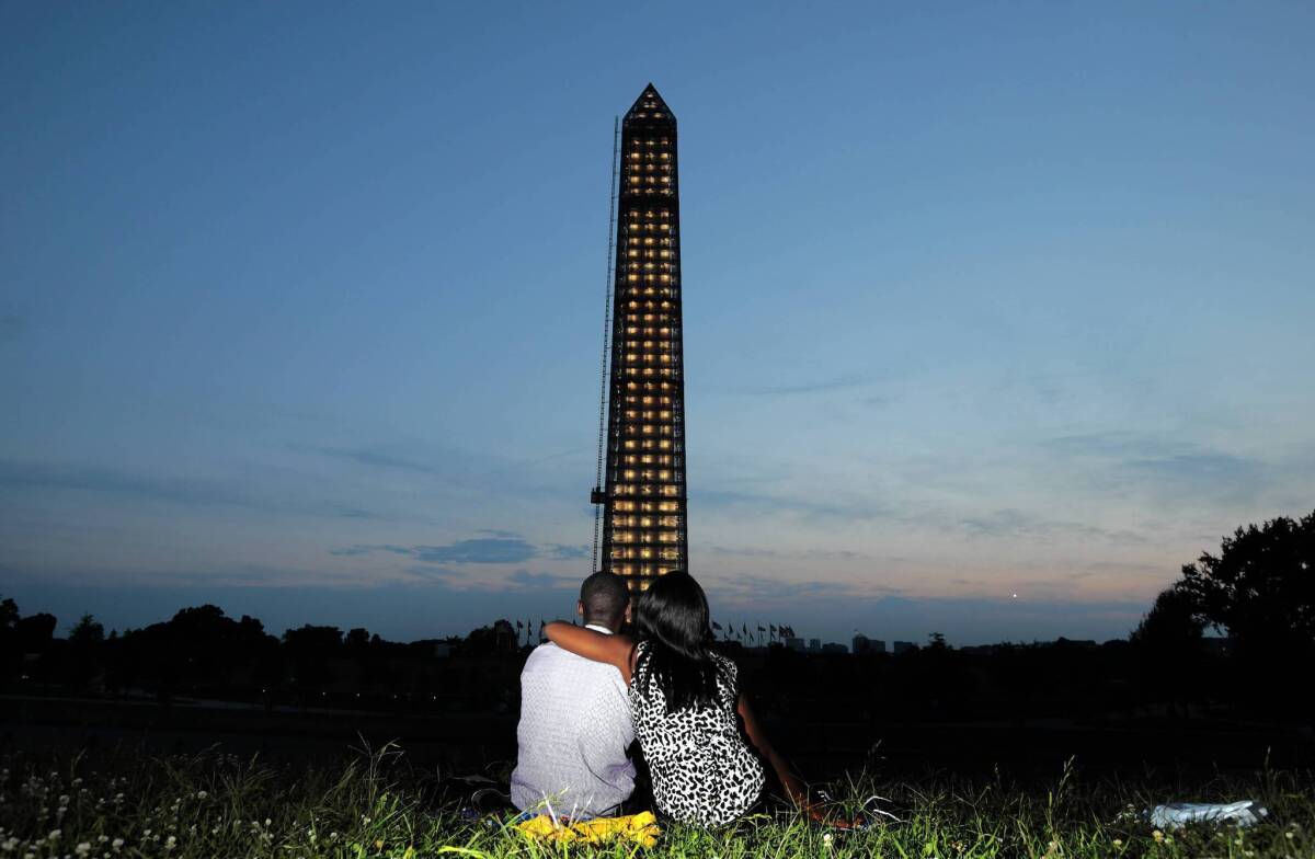 Many admire the under-renovation look of the Washington Monument, especially at night.
