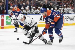 Los Angeles Kings' Blake Lizotte (46) and Edmonton Oilers' Vincent Desharnais (73) vie for the puck during the first period of Game 2 of an NHL hockey Stanley Cup first-round playoff series Wednesday, April 19, 2023, in Edmonton, Alberta. (Jason Franson/The Canadian Press via AP)