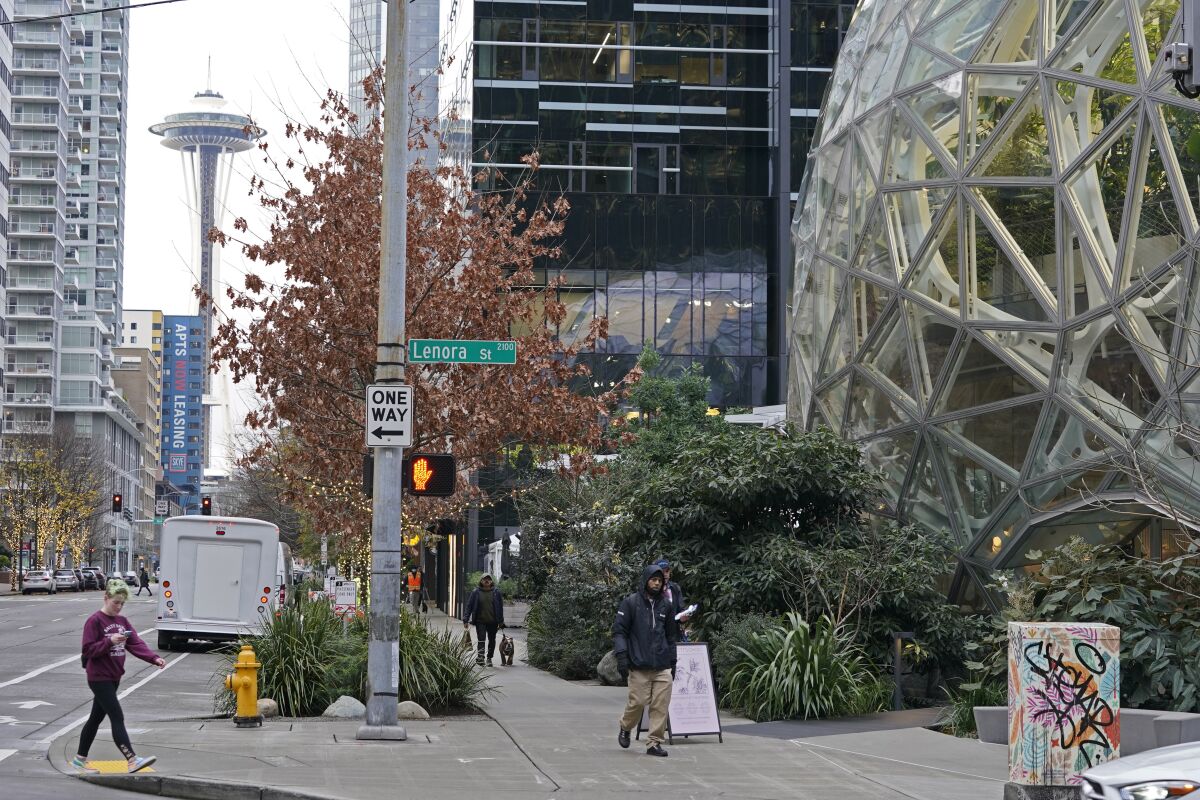 The Amazon Spheres on the company's corporate campus are shown near the Space Needle in downtown Seattle, Tuesday, Dec. 7, 2021. Amazon Web Services suffered a major outage Tuesday, the company said, disrupting access to many popular sites. The company provides cloud computing services to many governments, universities and companies, including The Associated Press. (AP Photo/Ted S. Warren)