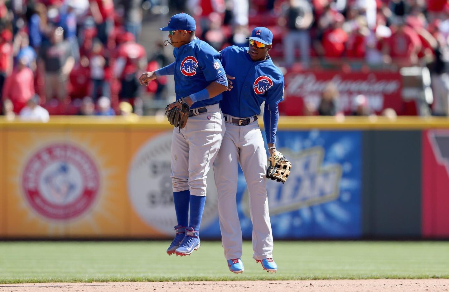 Starlin Castro celebrates with Dexter Fowler after the last out of the 5-2 win over the Reds at Great American Ball Park.