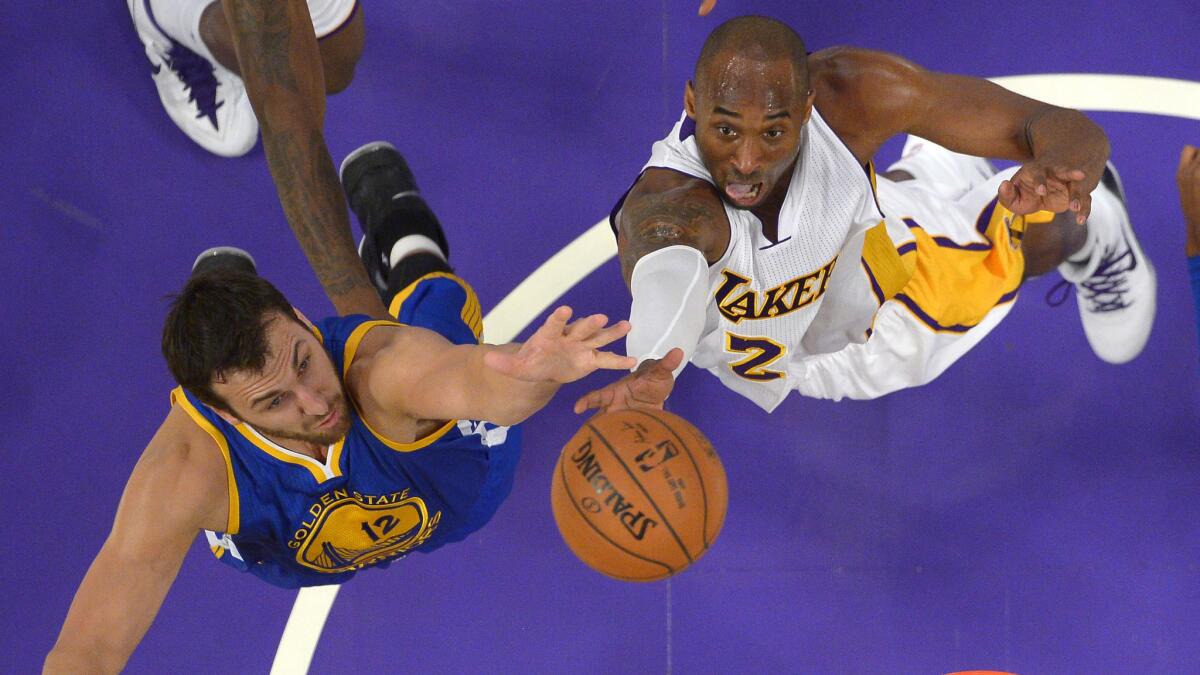 Lakers guard Kobe Bryant puts up a shot over Golden State Warriors center Andrew Bogut during their Nov. 16 game at Staples Center.