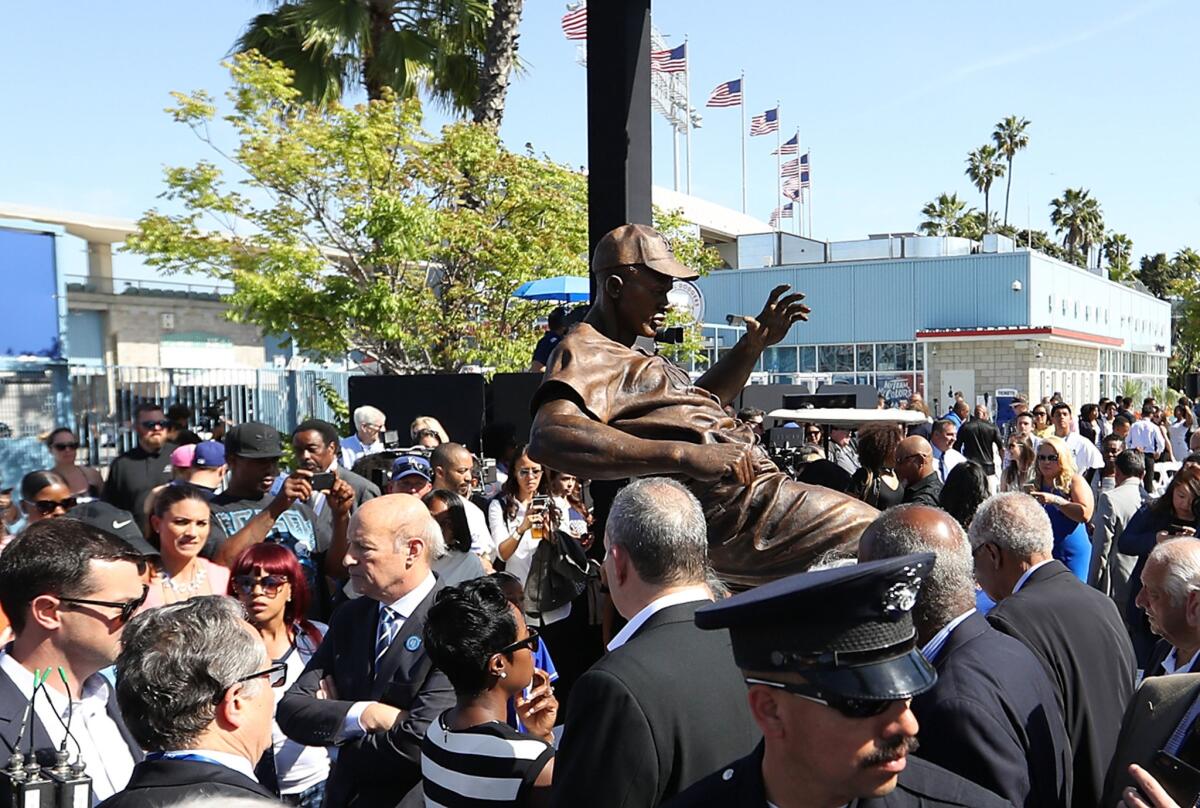 LOS ANGELES, CA - APRIL 15: A general view of the Jackie Robinson statue is seen with owner Stan Kasten, fifth from left, standing next to the statue after its unveiling at Dodger Stadium on April 15, 2017 in Los Angeles, California. (Photo by Victor Decolongon/Getty Images) ** OUTS - ELSENT, FPG, CM - OUTS * NM, PH, VA if sourced by CT, LA or MoD **