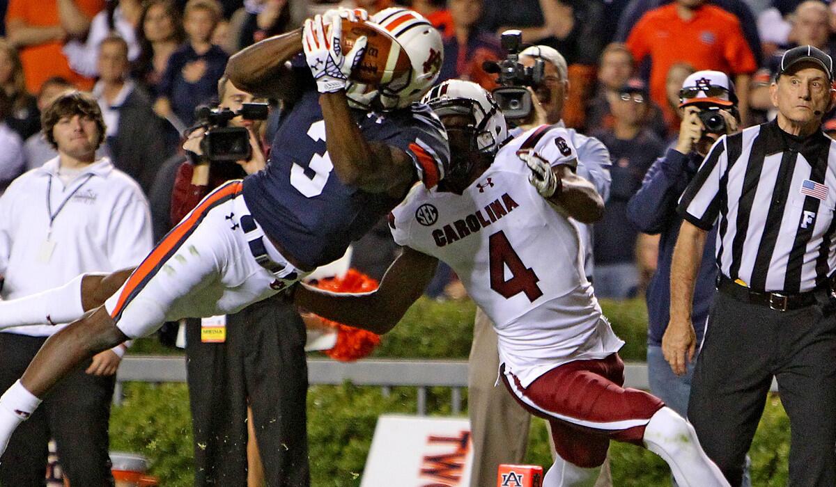 Auburn defensive back Jonathan Jones intercepts a pass intended for South Carolina receiver Shaq Roland in the second half in a 42-35 win that sets the stage for the No. 3-ranked Tigers to play No. 4 Mississippi State on Saturday.