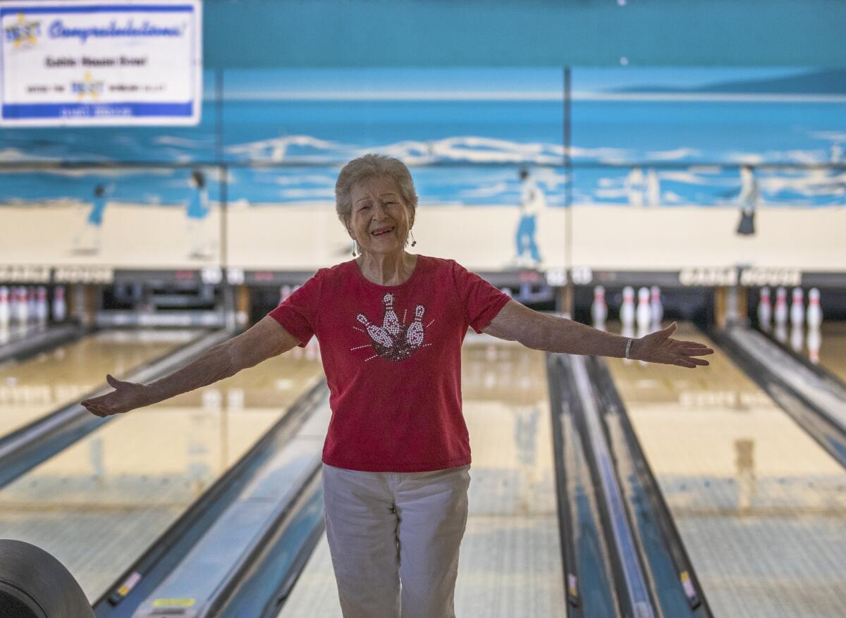 Lillian Solomon, who is turning 100 on Sept. 18, celebrates getting a strike for her team.