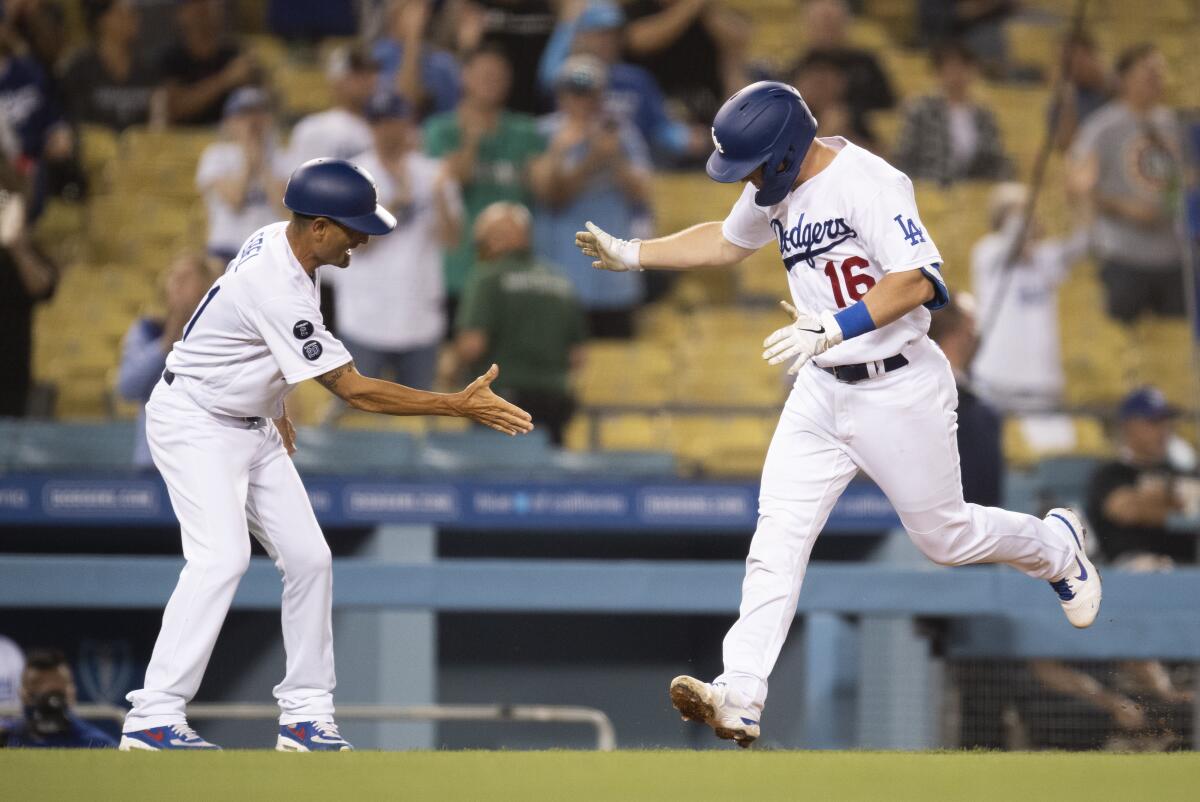 Chris Taylor of the Los Angeles Dodgers celebrates his run from a