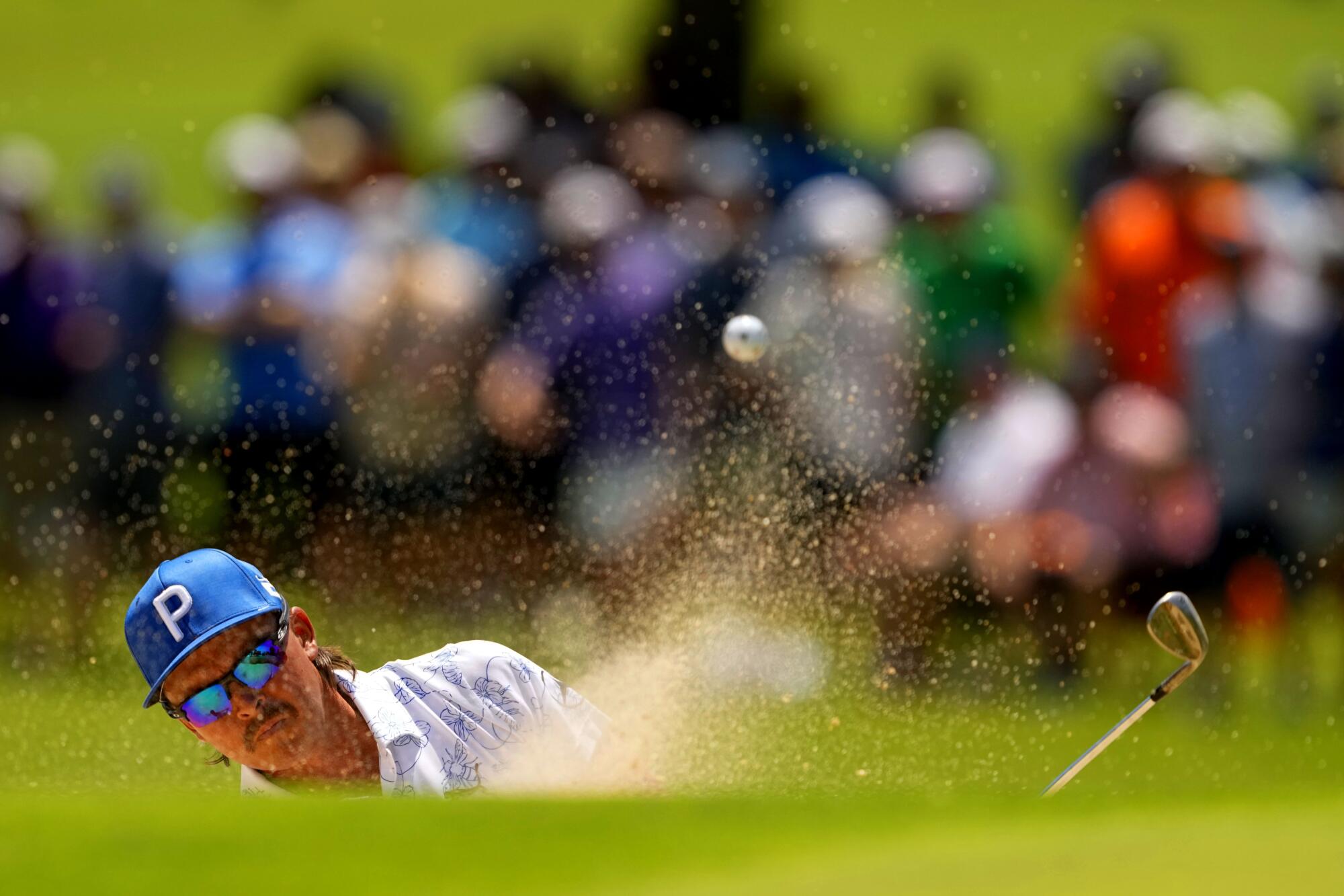 Rickie Fowler hits from the bunker on the first hole during the first round of the PGA Championship at Southern Hills.