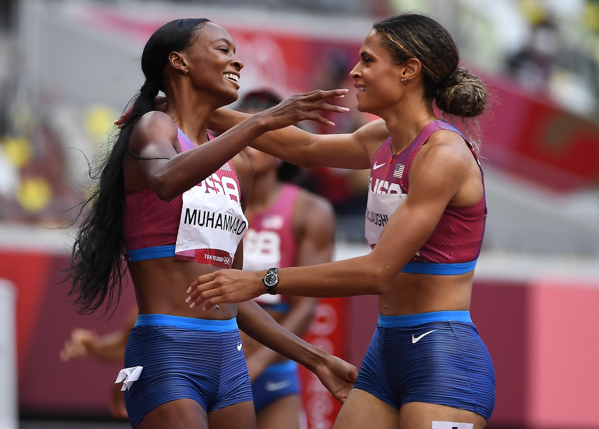 Gold medalist Sydney McLaughlin, right, and silver medalist Dalilah Muhammad celebrate after the 400-meter hurdles.